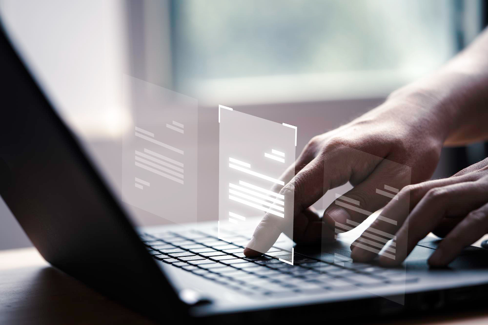 Hand using laptop computer with virtual screen and document for online approve paperless quality assurance and ERP management concept<br />
